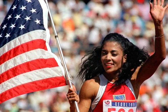 US sprinter Florence Griffith-Joyner waving with the &quot;Stars and Stripes&quot; after winning the Women&#039;s 100 meters sprint final of the 1988 Olympic Games in Seoul, September 25, 1988. Women& ...