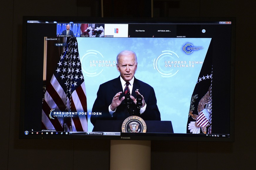 epa09152949 U.S. President Joe Biden is seen on the screen as European Council President Charles Michel attends a virtual U.S. global climate summit, in Brussels, Belgium, 22 April 2021. Around 40 int ...