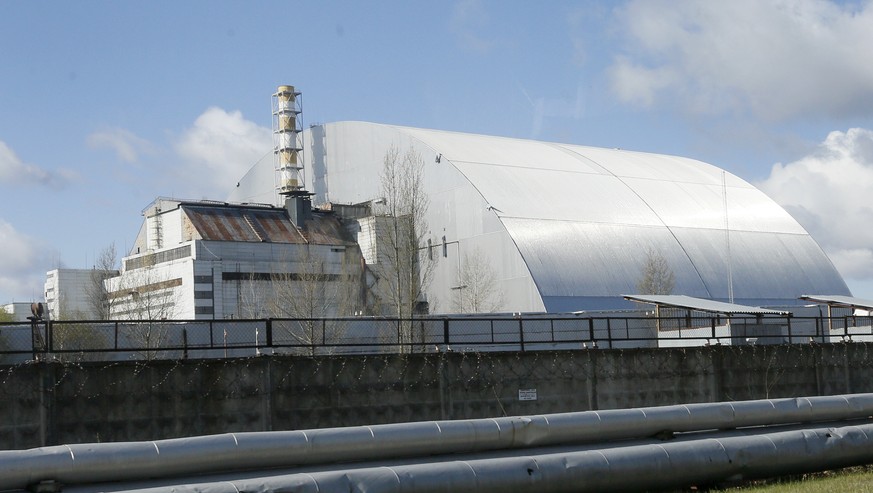 A shelter construction covers the exploded reactor at the Chernobyl nuclear plant, in Chernobyl,Ukraine, Tuesday, April 27, 2021. The Ukrainian authorities decided to use the deserted exclusion zone a ...