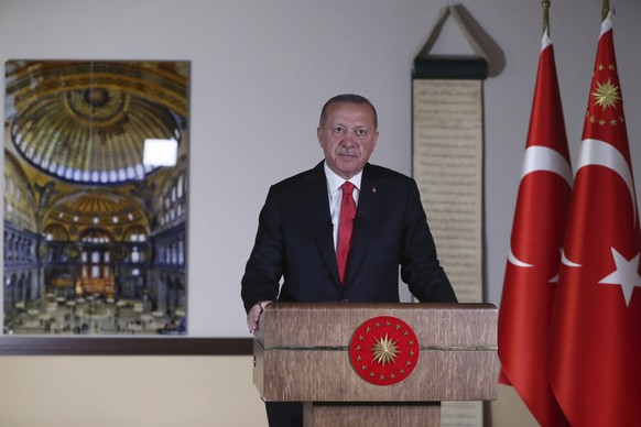 Turkey&#039;s President Recep Tayyip Erdogan, backdropped by a photograph of the Byzantine-era Hagia Sophia, one of Istanbul&#039;s main tourist attractions in the historic Sultanahmet district of Ist ...