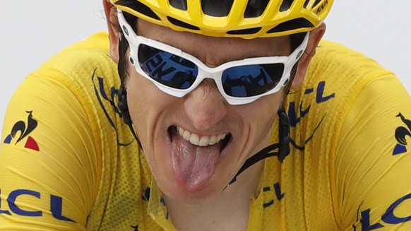 Britain&#039;s Geraint Thomas, wearing the overall leader&#039;s yellow jersey, grimaces as he crosses the finish line of the seventeenth stage of the Tour de France cycling race over 65 kilometers (4 ...