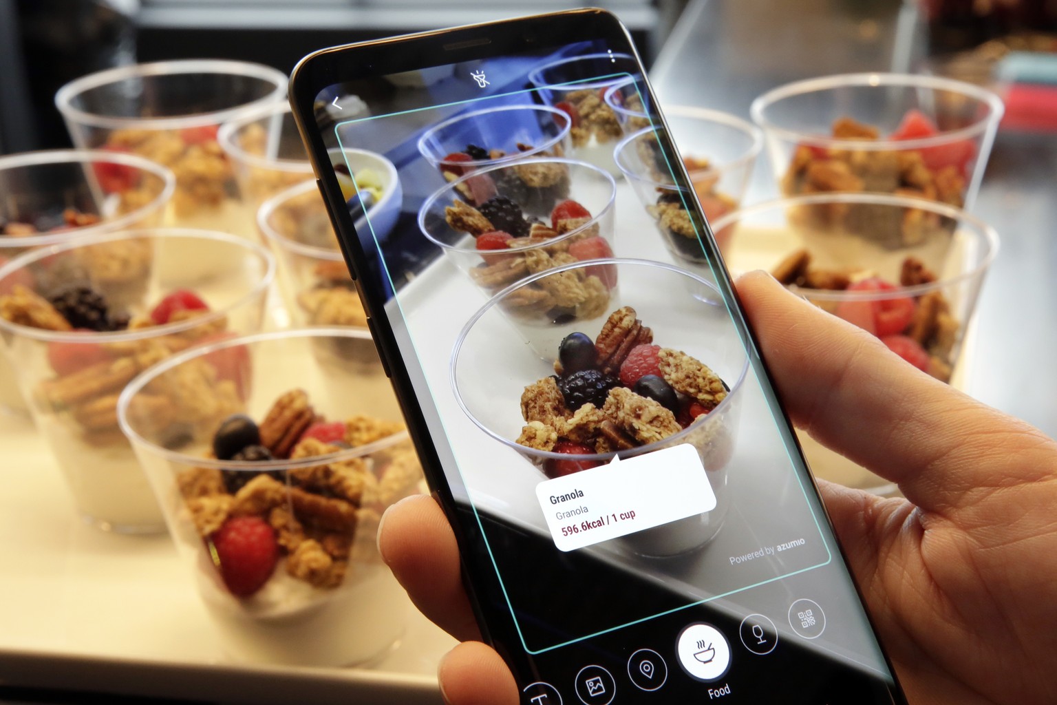 FILE- In this Feb. 21, 2018, file photo the Bixby virtual assistant software of a Samsung Galaxy S9 Plus mobile phone identifies food and displays its calorie content during a product preview in New Y ...