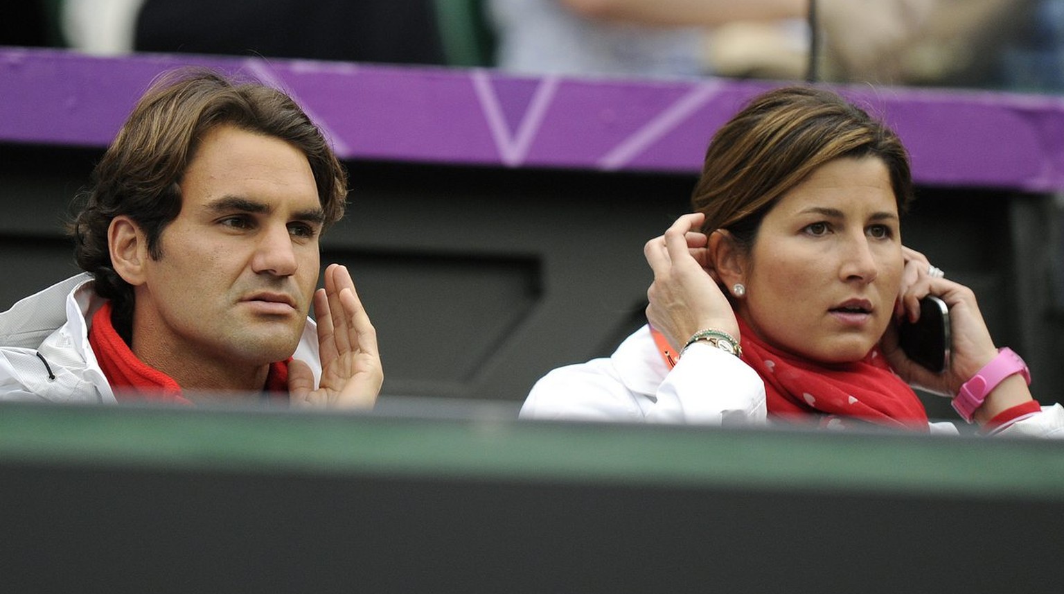 Switzerland&#039;s Roger Federer, left, and his wife Mirka follow the Men&#039;s first round singles match between Switzerland&#039;s Stanislas Wawrinka and Britain&#039;s Andy Murray at Wimbledon in  ...