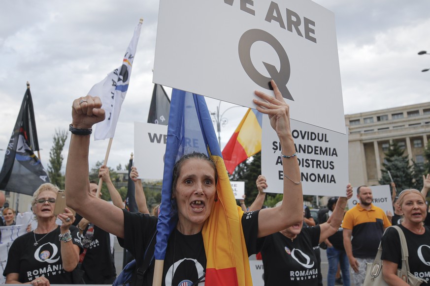 Romanian supporters of QAnon shout slogans against the government&#039;s measures to prevent the spread of the COVID-19 infections, like wearing a face mask, during a rally in Bucharest, Romania, Mond ...