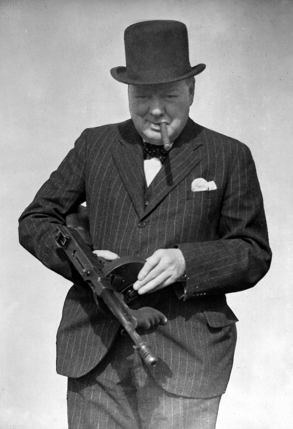 This is a Aug. 1, 1940 photo provided by the British government, Britain&#039;s Prime Minister Winston Churchill tries a Tommy Gun during a visit to north-east England. Churchill Britain&#039;s famous ...