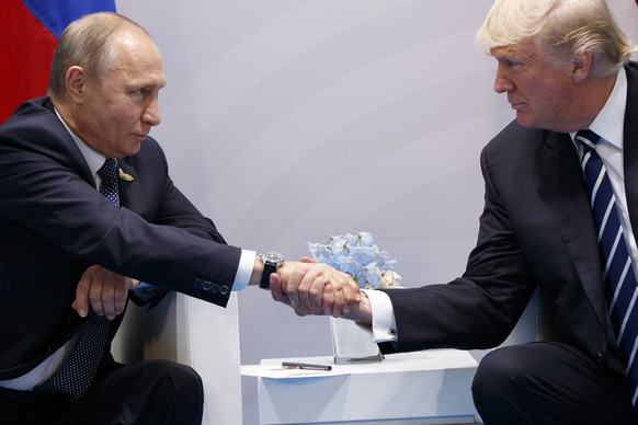 FILE - In this July 7, 2017, file photo, President Donald Trump shakes hands with Russian President Vladimir Putin at the G20 Summit in Hamburg. Trump has strenuously sought to keep an entente cordial ...