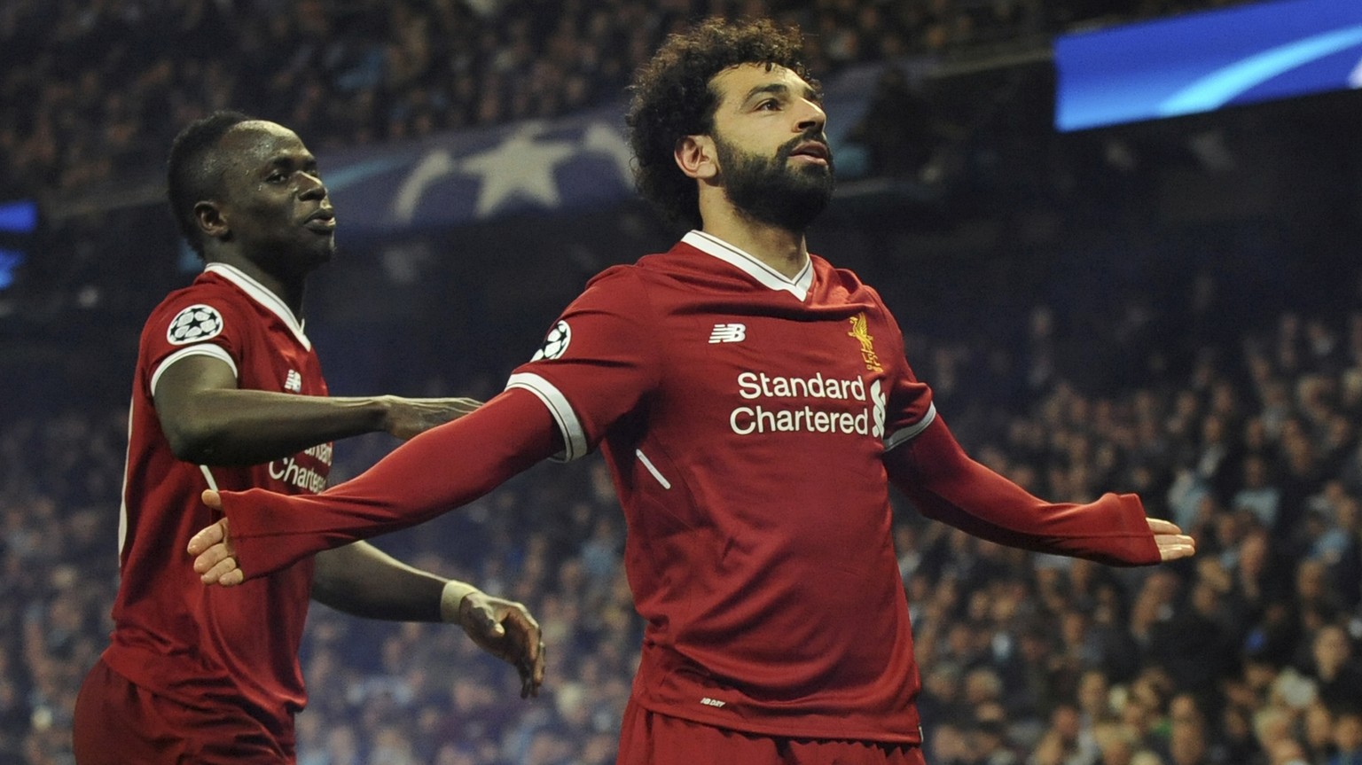 Liverpool&#039;s Mohamed Salah, right, celebrates scoring his side&#039;s first goal with Liverpool&#039;s Sadio Mane during the Champions League quarterfinal second leg soccer match between Mancheste ...