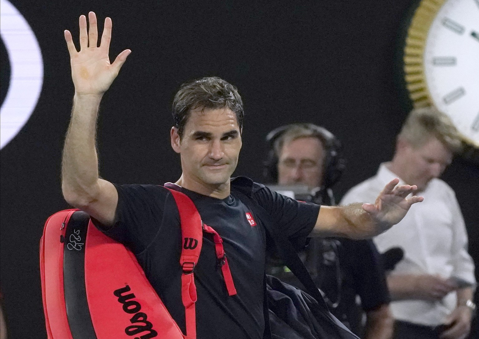 Switzerland&#039;s Roger Federer waves as he leaves Rod Laver Arena following his loss to Serbia&#039;s Novak Djokovic in their semifinal match at the Australian Open tennis championship in Melbourne, ...