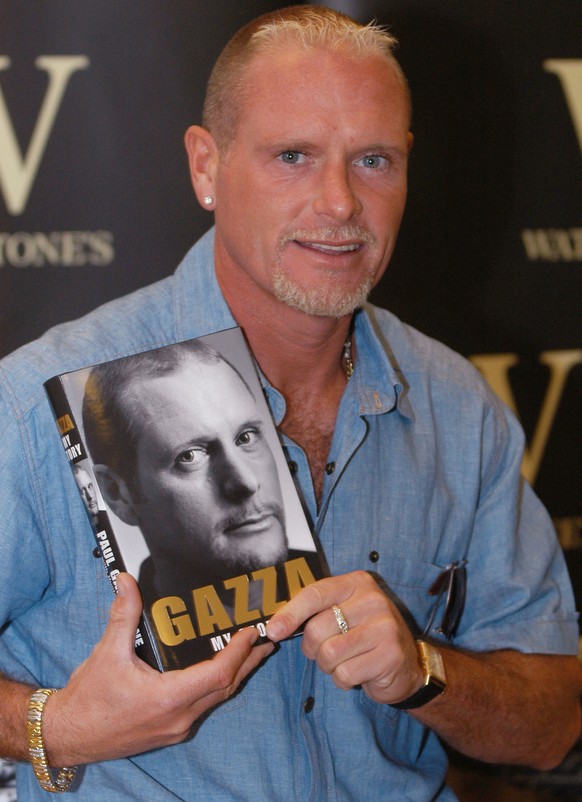 Football player, Paul Gascoigne poses with a copy of his new autobiography entitled &quot;Gazza&quot; at a book launch at Waterstone&#039;s book shop in the City of London, Monday June 21, 2004. (AP P ...