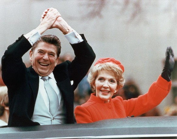 Ronald and Nancy Reagan waving and clasping hands in victory at Reagan&#039;s first inauguration, January 20, 1981. (Photo by © CORBIS/Corbis via Getty Images)