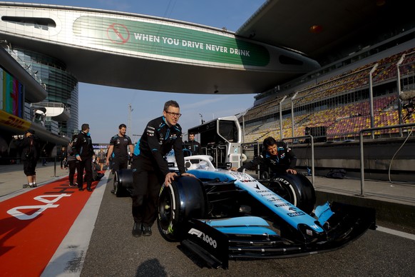 epa07498570 Williams mechanics push the car of British Formula One driver George Russell of Williams along the pitlane ahead of the Chinese Formula One Grand Prix at the Shanghai International circuit ...