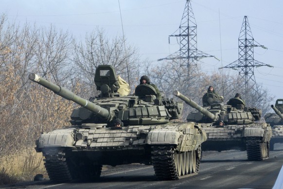 FILE In this file photo taken on Monday, Nov. 10, 2014, Pro-Russian rebel military vehicle convoy move towards Donetsk , Eastern Ukraine. Russia has denied it is sending arms and troops to support the ...