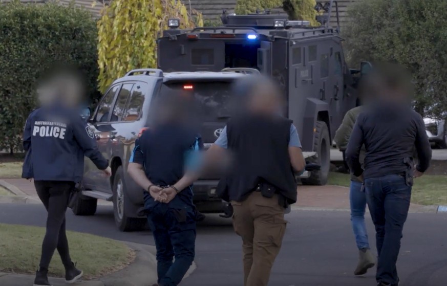 epa09254566 An undated handout picture provided by Victoria Police of an arrest in Sydenham, Victoria, Australia, as part of Operation Ironside, issued 08 June 2021. Acts of murder, weapon use and dru ...