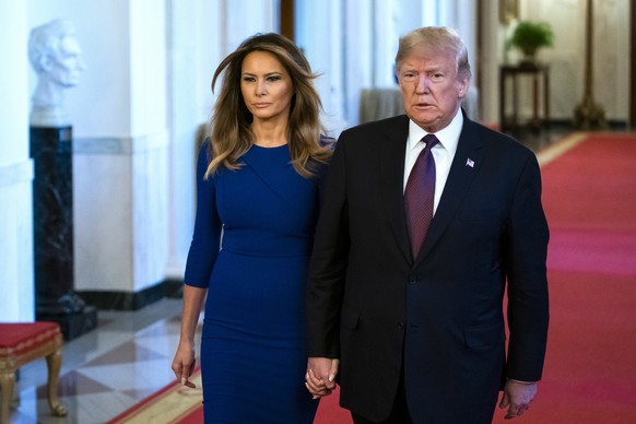 epa07171209 US President Donald J. Trump (R) and First Lady Melania Trump (L) prepare to award the Presidential Medal of Freedom to seven individuals in the East Room of the White House in Washington, ...