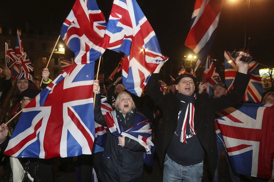 Brexit supporters celebrate at George Square in Glasgow, England, as Britain left the European Union on Friday, Jan. 31, 2020. Britain officially leaves the European Union on Friday after a debilitati ...