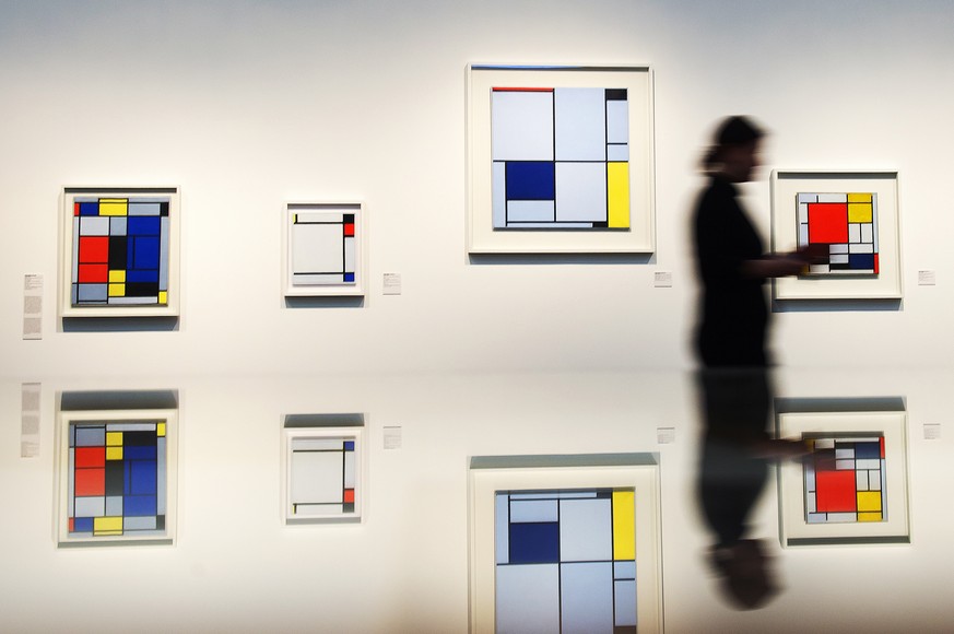 In this picture taken with a long time exposure a visitor is reflected in a showcase in front of works by Piet Mondrian during the press preview of the exhibition &#039;Visionary Spaces. Kandinsky, Mo ...