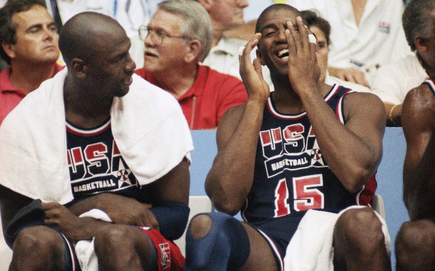 FILE - In this Aug. 4, 1992, file photo, Earvin &quot;Magic&quot; Johnson, right, laughs as he sits with Michael Jordan during a basketball game against Puerto Rico in Barcelona, Spain. (AP Photo/Susa ...