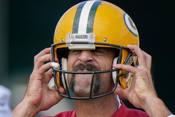 Green Bay Packers&#039; Aaron Rodgers puts on his helmet during NFL football training camp Saturday, Aug. 15, 2020, in Green Bay, Wis. (AP Photo/Morry Gash)