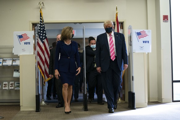 President Donald Trump walks with Wendy Sartory Link, Supervisor of Elections Palm Beach County, after casting his ballot for the presidential election, Saturday, Oct. 24, 2020, in West Palm Beach, Fl ...