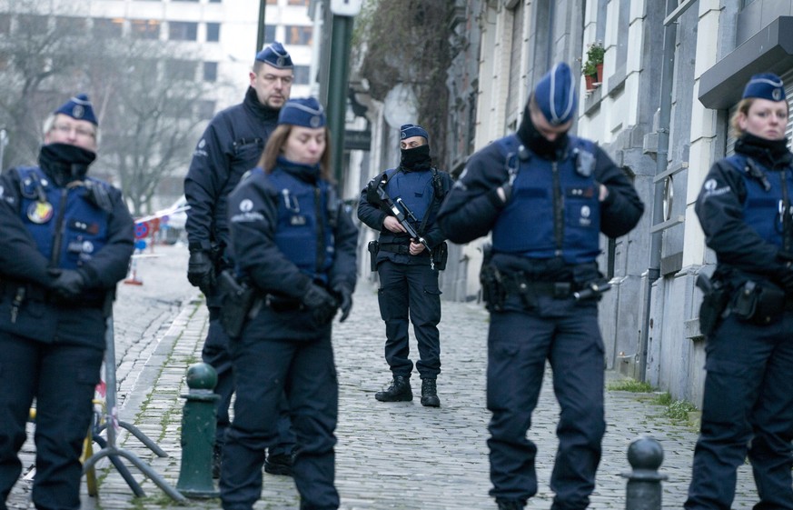 Police guard as they await a convoy carrying Salah Abdeslam and other members of the trial arrives under police guard at the Brussels Justice Palace in Brussels on Monday, Feb. 5, 2018. Salah Abdeslam ...