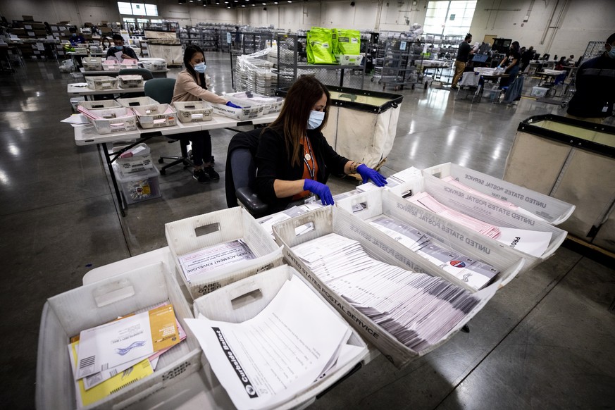 epa08794389 Election workers check the signatures on mail-in ballots and for irregularities at the Los Angeles County Registrar Recorders&#039; mail-in ballot processing center at the Pomona Fairplex  ...