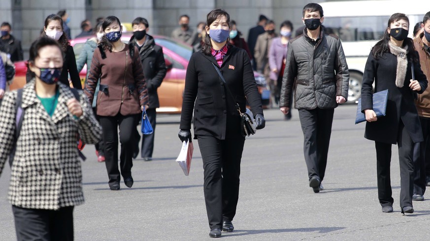 Pedestrians wear face masks to help prevent the spread of the coronavirus, Wednesday, April 1, 2020, in Pyongyang, North Korea. The new coronavirus causes mild or moderate symptoms for most people, bu ...