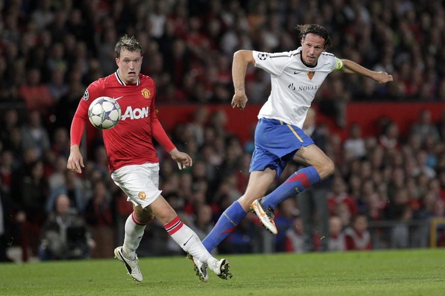 Basel&#039;s Marco Streller, right, shoots to goal in front of Manchester&#039;s Phil Jones, left, during the UEFA Champions League, Group C, soccer match between Manchester United FC and FC Basel, at ...