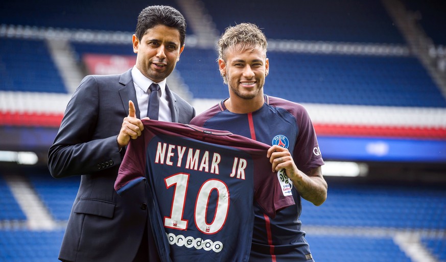 epa06124324 Paris Saint Germain&#039;s chairman and CEO Nasser Al-Khelaif (L) and Brazilian striker Neymar Jr (R) pose for photographs with his new PSG jersey after a press conference at the Parc des  ...