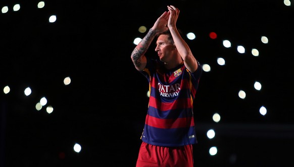 FILE - In this Aug. 5, 2015 file photo, Barcelona&#039;s Lionel Messi applauds as he enters the pitch during the presentation of the team for the new season at the Camp Nou stadium in Barcelona, Spain ...