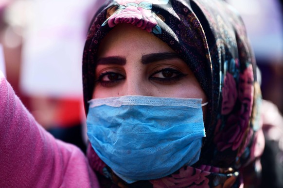 epa08215010 An Iraqi woman wears a mask during a demonstration at the Al-Tahrir square in central Baghdad, Iraq, 13 February 2020. Hundreds of Iraqi women staged a demonstration in central Baghdad to  ...