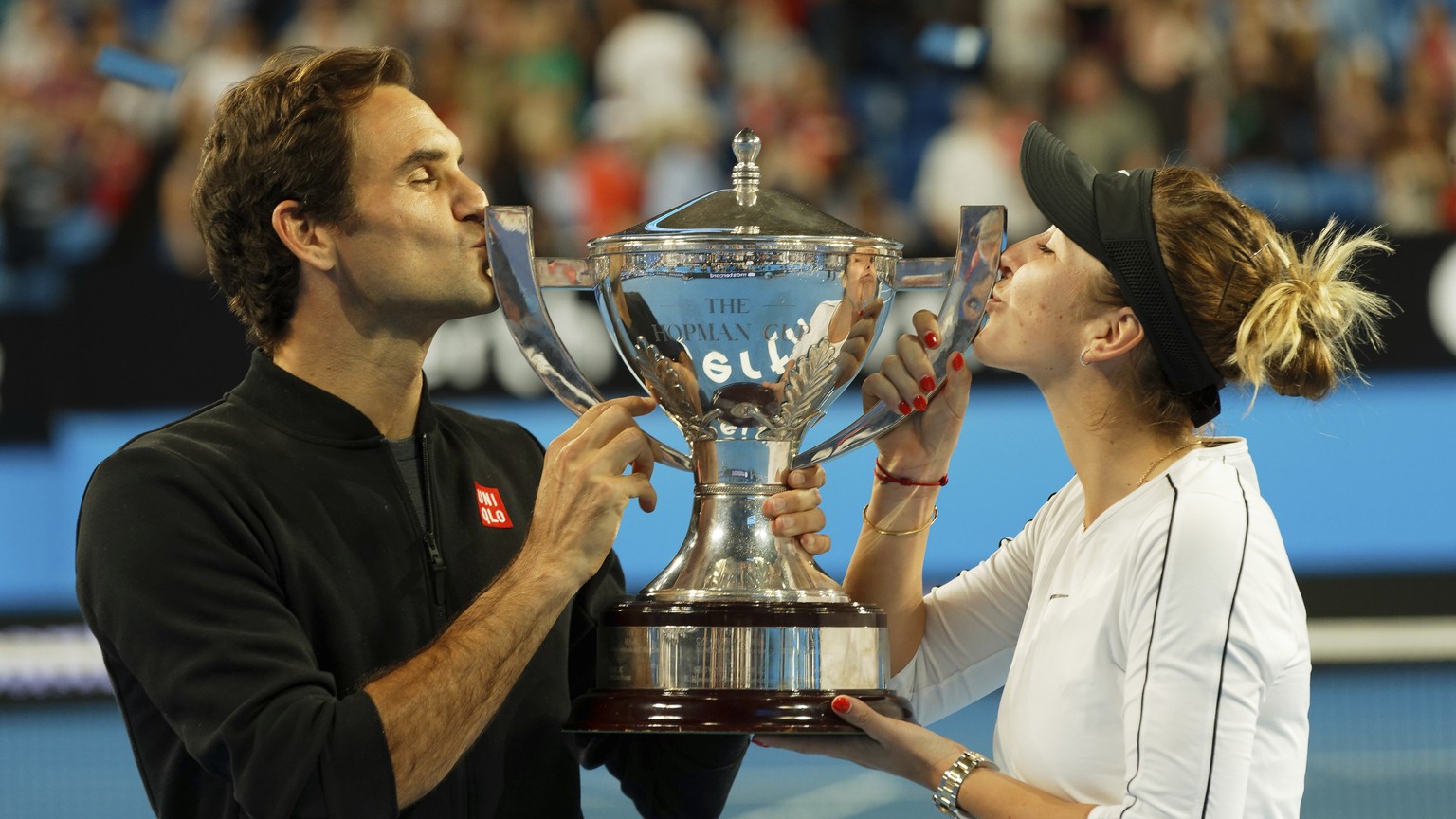 Switzerland&#039;s Roger Federer and Belinda Bencic kiss the trophy after winning the final against Alexander Zverev and Angelique Kerber of Germany at the Hopman Cup in Perth, Australia, Saturday Jan ...