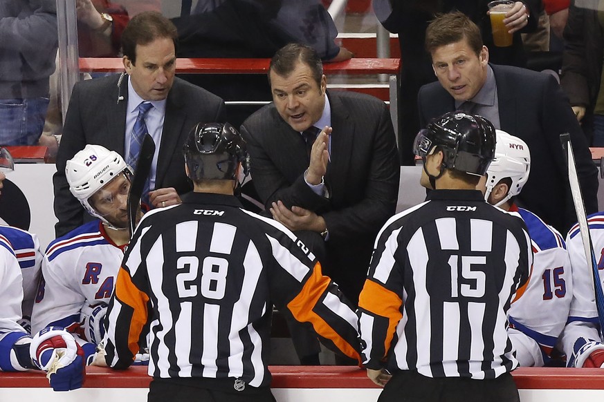 Mar 4, 2016; Washington, DC, USA; New York Rangers head coach Alain Vigneault (M) talks to referee Chris Lee (28) while challenging a goal in the second period against the Washington Capitals at Veriz ...