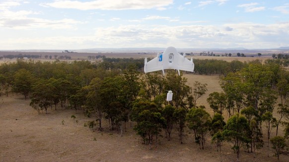In this image released by Google, a drone lowers a package to the ground in Queensland, Australia. Google on August 28, 2014, said it is testing using drones to deliver items bought online, putting it ...