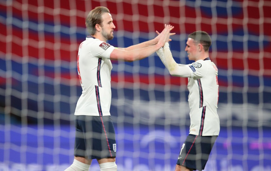 epa09109115 England&#039;s Harry Kane (L) reacts with England&#039; Phil Foden (R) after he scores the 1-0 goal from a penalty during the FIFA World Cup 2022 qualifying soccer match between England an ...