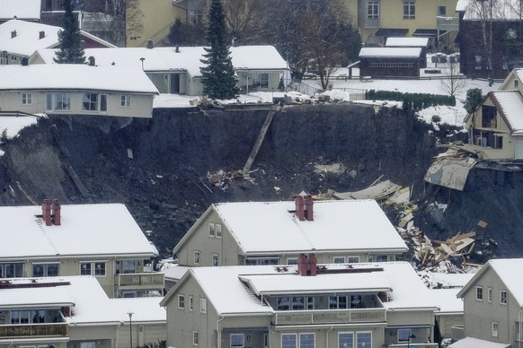 epa08911126 A view of the area of a landslide in the village Ask, some 40 km north of Oslo, Norway, 30 December 2020. According to the police, several people are still missing after a big landslide hi ...