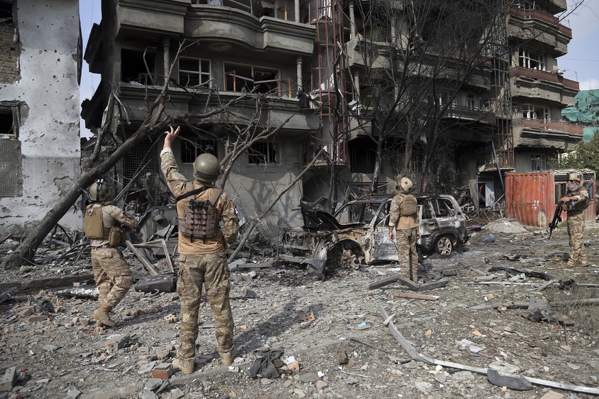 Afghan security forces inspect the aftermath of Sunday&#039;s attack in Kabul, Afghanistan, Monday, July 29, 2019. A complex attack against the office of the president&#039;s running mate and a former ...
