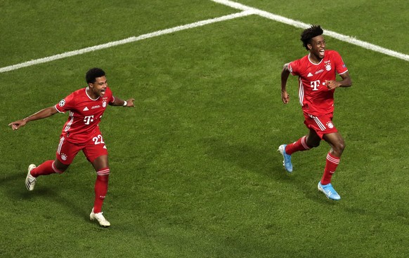 epa08620784 Kingsley Coman (R) of Bayern celebrates with teammate Serge Gnabry after scoring the opening goal during the UEFA Champions League final between Paris Saint-Germain and Bayern Munich in Li ...