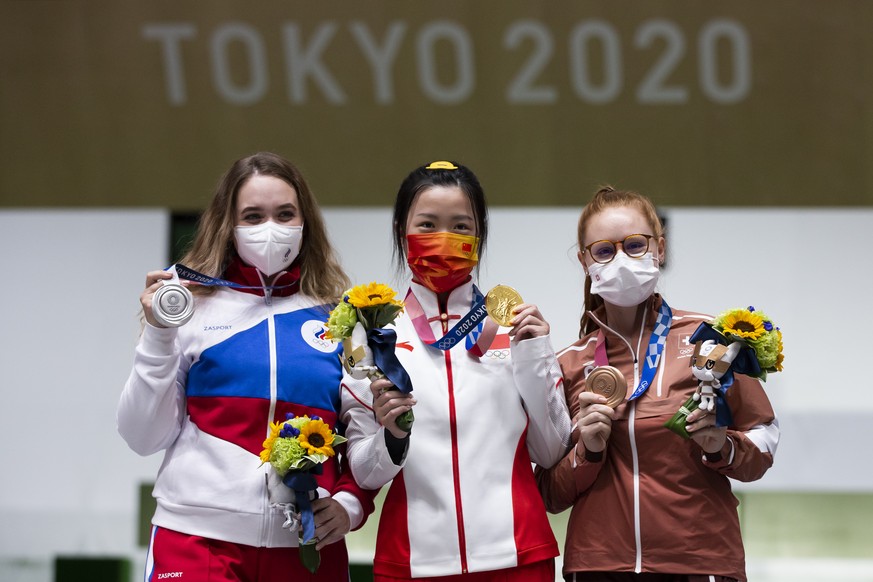 Bronze medal winner Nina Christen of Switzerland, gold medal winner Qian Yang of China and silver medal winner Anastasiia Galashina of Russian Olympic Committee (ROC), from right, pose during the meda ...