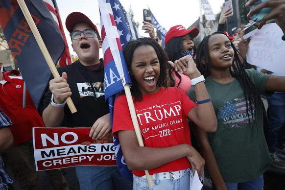 Trump supporters shout as Vice President Mike Pence&#039;s motorcade drives past during a protest outside the vice-presidential debate, Wednesday, Oct. 7, 2020, in Salt Lake City. (AP Photo/Jeff Swing ...