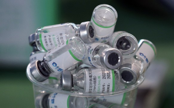 Empty vials of China&#039;s Sinopharm vaccine sit in a cup during a priority COVID-19 vaccination campaign of health workers at a public hospital in Lima, Peru, Wednesday, Feb. 10, 2021. Peru received ...