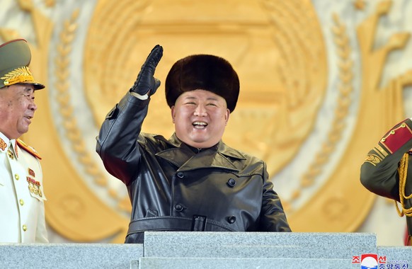 epa08938276 A photo released by the official North Korean Central News Agency (KCNA) shows North Korean leader Kim Jong-un (C) reacting during a military parade held to mark the 8th Congress of the Wo ...