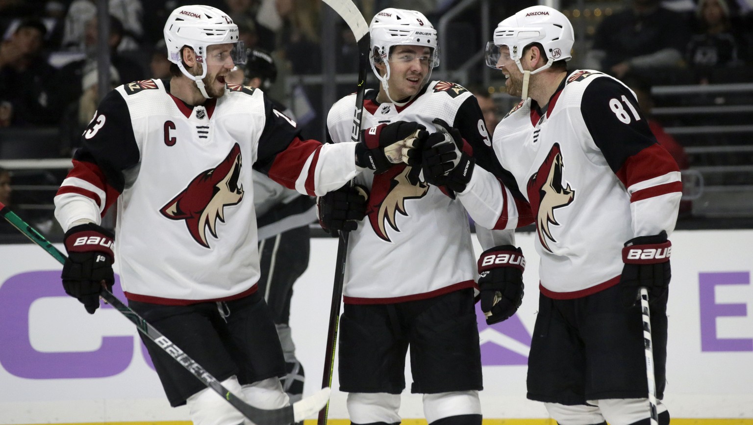 FILE - In this Saturday, Nov. 23, 2019, file photo, Arizona Coyotes center Phil Kessel, right, celebrates his goal with defenseman Oliver Ekman-Larsson, left, of Sweden, and center Clayton Keller, cen ...