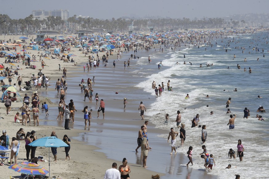 Visitors crowd the beach Sunday, July 12, 2020, in Santa Monica, Calif., amid the coronavirus pandemic. A heat wave has brought crowds to California&#039;s beaches as the state grappled with a spike i ...