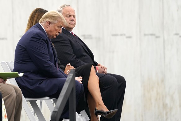 President Donald Trump sits on stage with first lady Melania Trump and Interior Secretary David Bernhardt at a 19th anniversary observance of the Sept. 11 terror attacks, at the Flight 93 National Mem ...