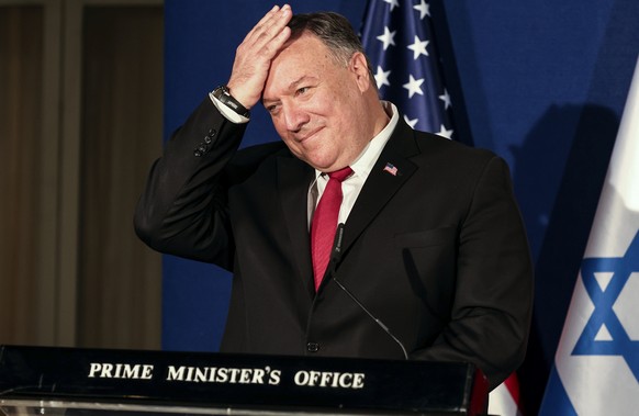U.S. Secretary of State Mike Pompeo pats his head during a joint press conference with Israeli Prime Minister Benjamin Netanyahu and Bahrain&#039;s Foreign Minister Abdullatif bin Rashid Alzayani afte ...