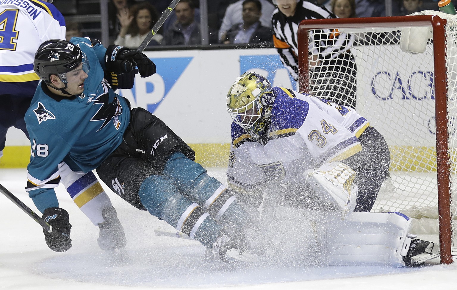 San Jose Sharks&#039; Timo Meier, left, collides with St. Louis Blues goalie Jake Allen (34) during the first period of an NHL hockey game Thursday, March 8, 2018, in San Jose, Calif. (AP Photo/Marcio ...