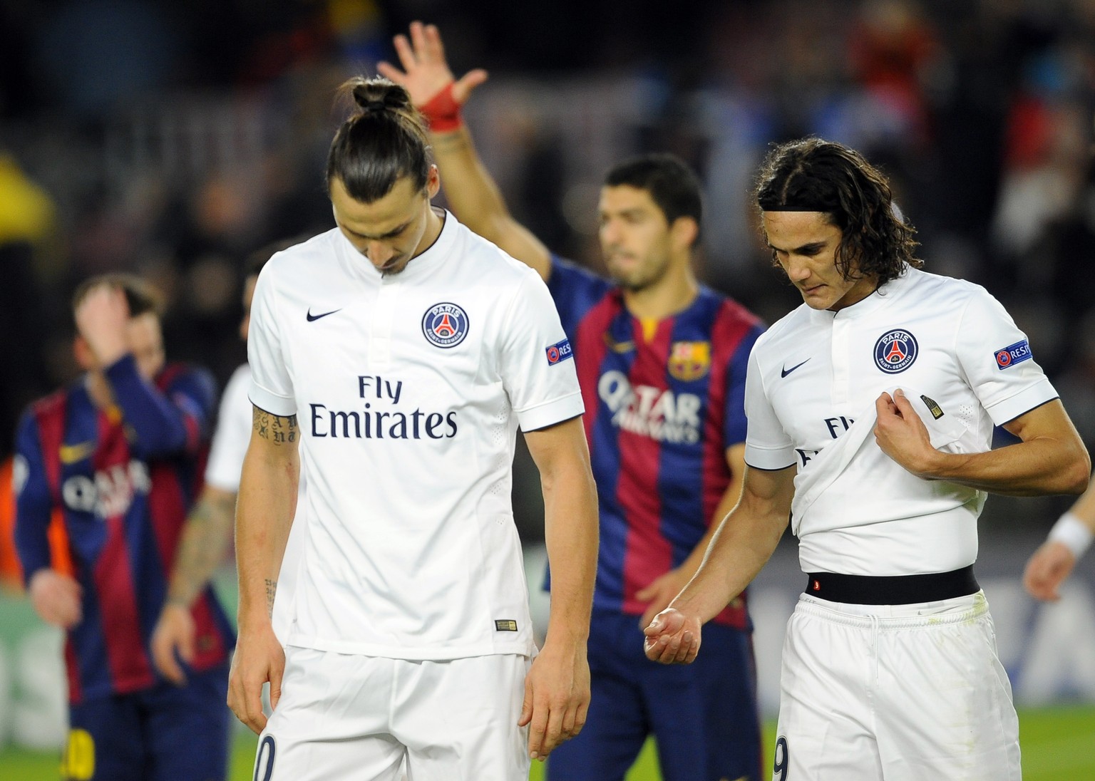 PSG players, Zlatan Ibrahimovic and Edinson Cavani, right, leave the pitch at the end of the Group F Champions League soccer match between FC Barcelona and PSG at the Camp Nou stadium in Barcelona, Sp ...