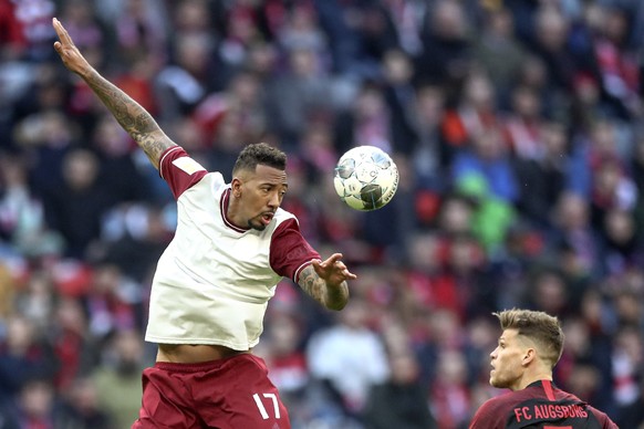 Bayern&#039;s Jerome Boateng jumps for a header next to Augsburg&#039;s Florian Niederlechner during the German Bundesliga soccer match between FC Bayern Munich and FC Augsburg in Munich, Germany, Sun ...
