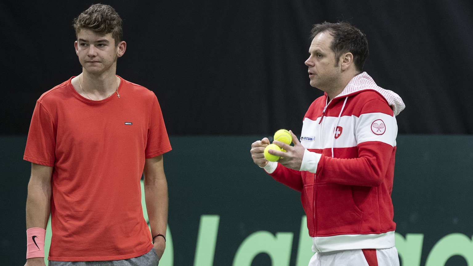Switzerland&#039;s Davis Cup team captain Severin Luethi, right, and his team player Jerome Kym, left, look on during a training session in the Swiss Tennis Arena in Biel, Switzerland, on Thursday, Ja ...