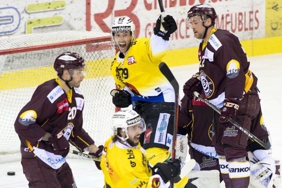 Bern&#039;s forward Daniele Grassi, center, celebrates the first goal in front of Geneve-Servette&#039;s defender Jonathan Mercier, right, during the fourth leg of the playoffs quarterfinals game of N ...